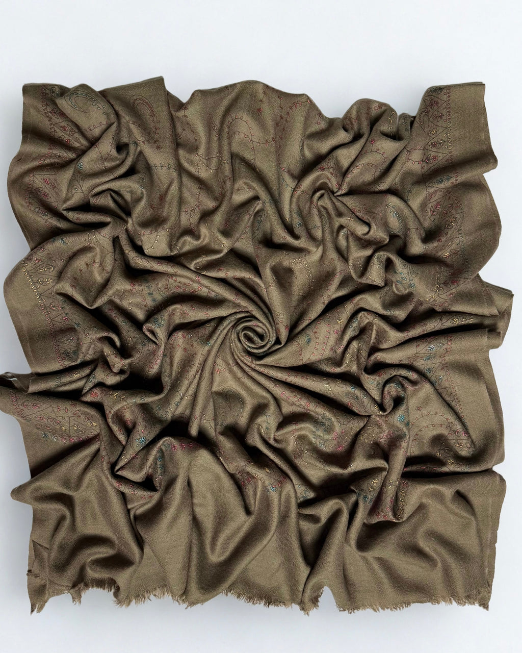 Olive brown Swati Shahtoosh shawl gathered in a swirl, the hand-embroidered paisley jaal covering the whole field