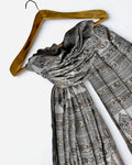 Silver grey Indian pashmina shawl laid flat, banded rows of paisley buta and geometric stripes with a plain ivory end panel
