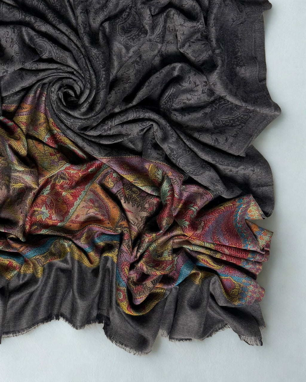Dark charcoal Palladar shawl swirled from above, the dark field over the saffron and crimson paisley palla