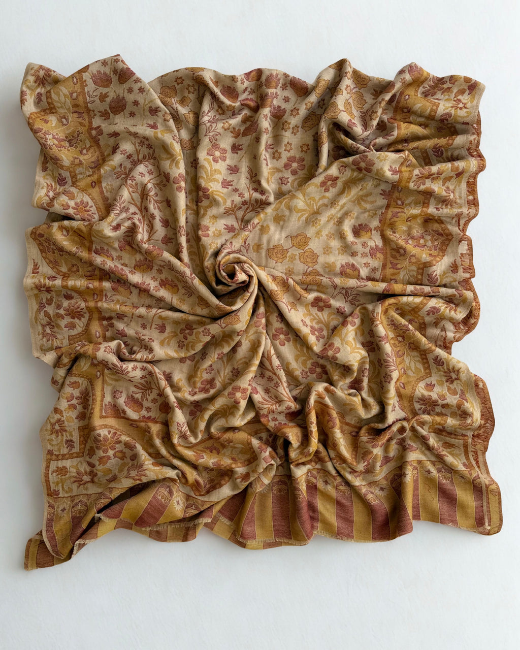 Detail of the scalloped border and striped colonnade end panel on a sand Kani pashmina shawl