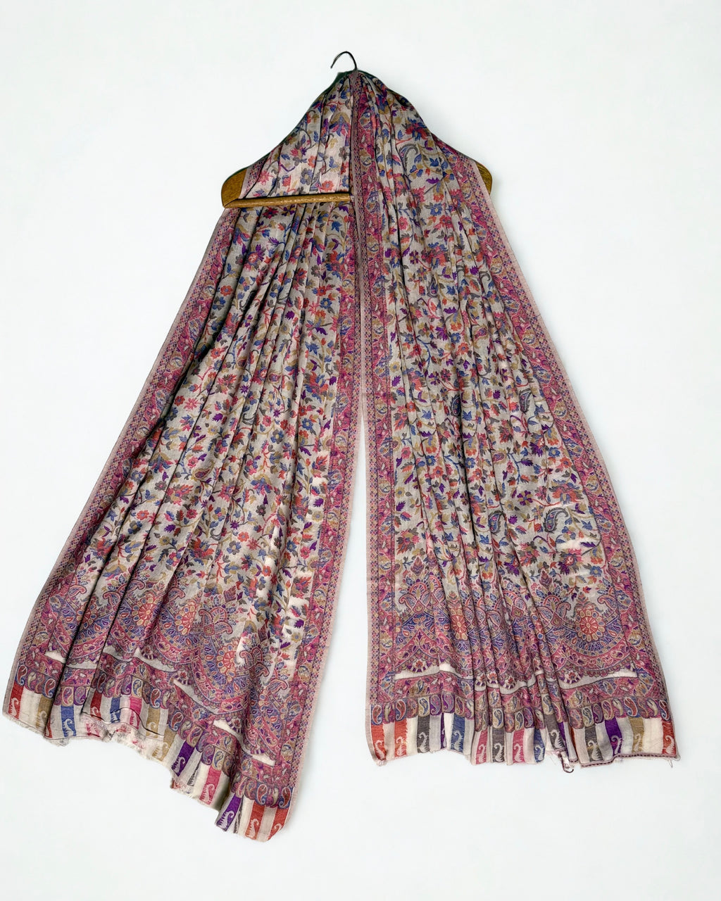 Almond Kani pashmina shawl folded back to show the cornflower blue and rose floral weave and scalloped border