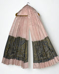 Blush pink Palladar ring shawl hanging from a wooden hanger, both woven paisley pallas visible at the ends