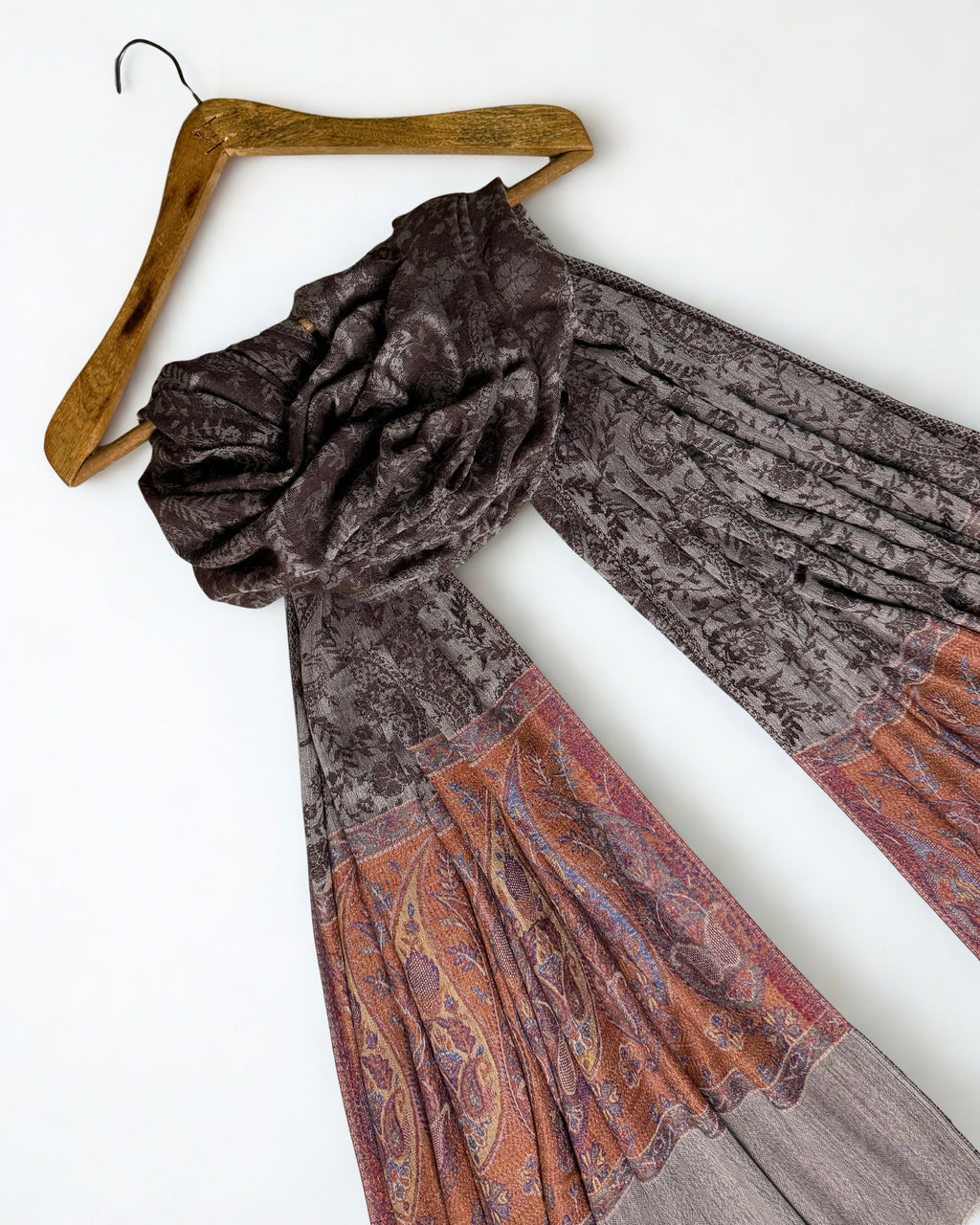 The tonal brown-on-brown paisley woven across the whole cocoa field