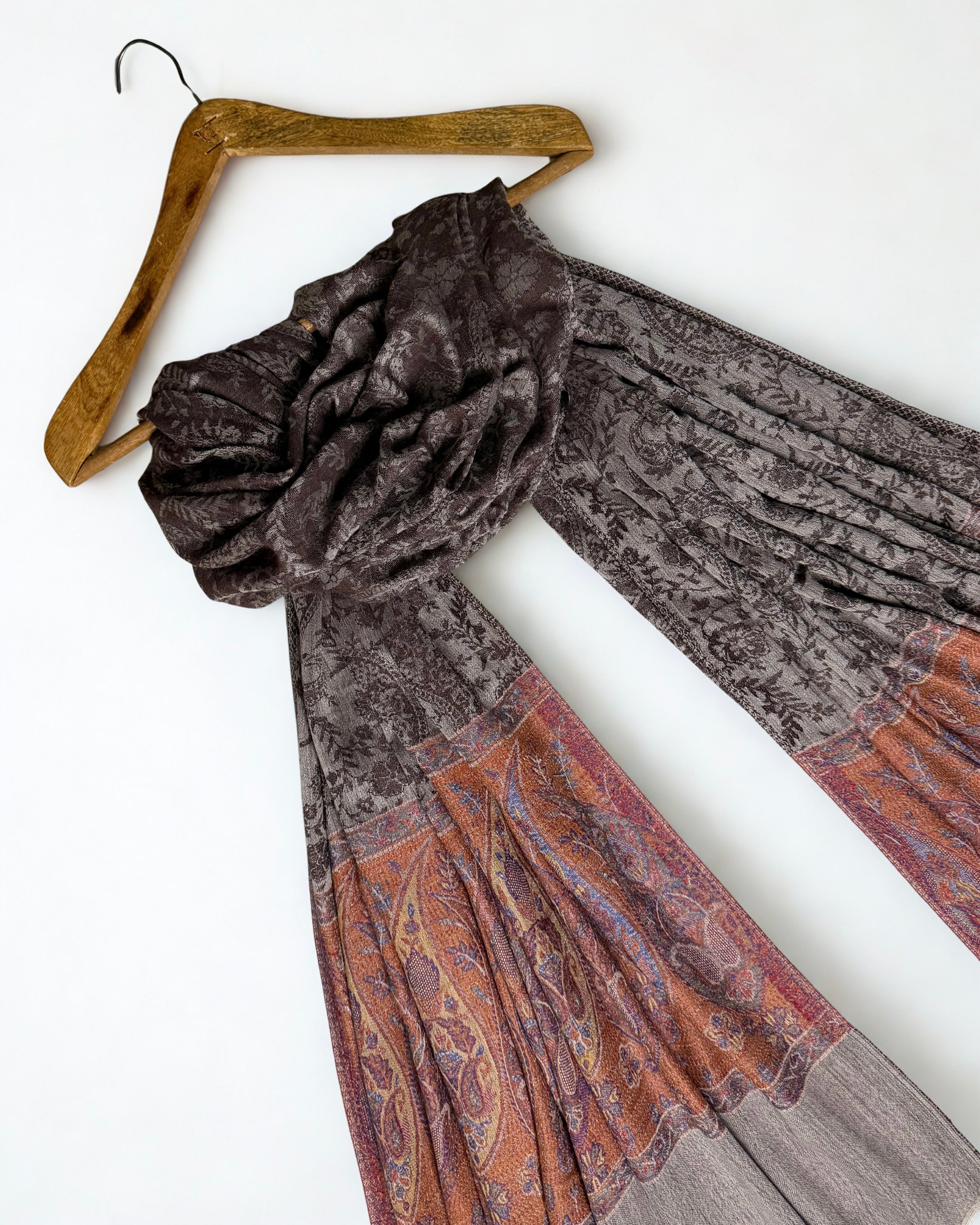 The tonal brown-on-brown paisley woven across the whole cocoa field