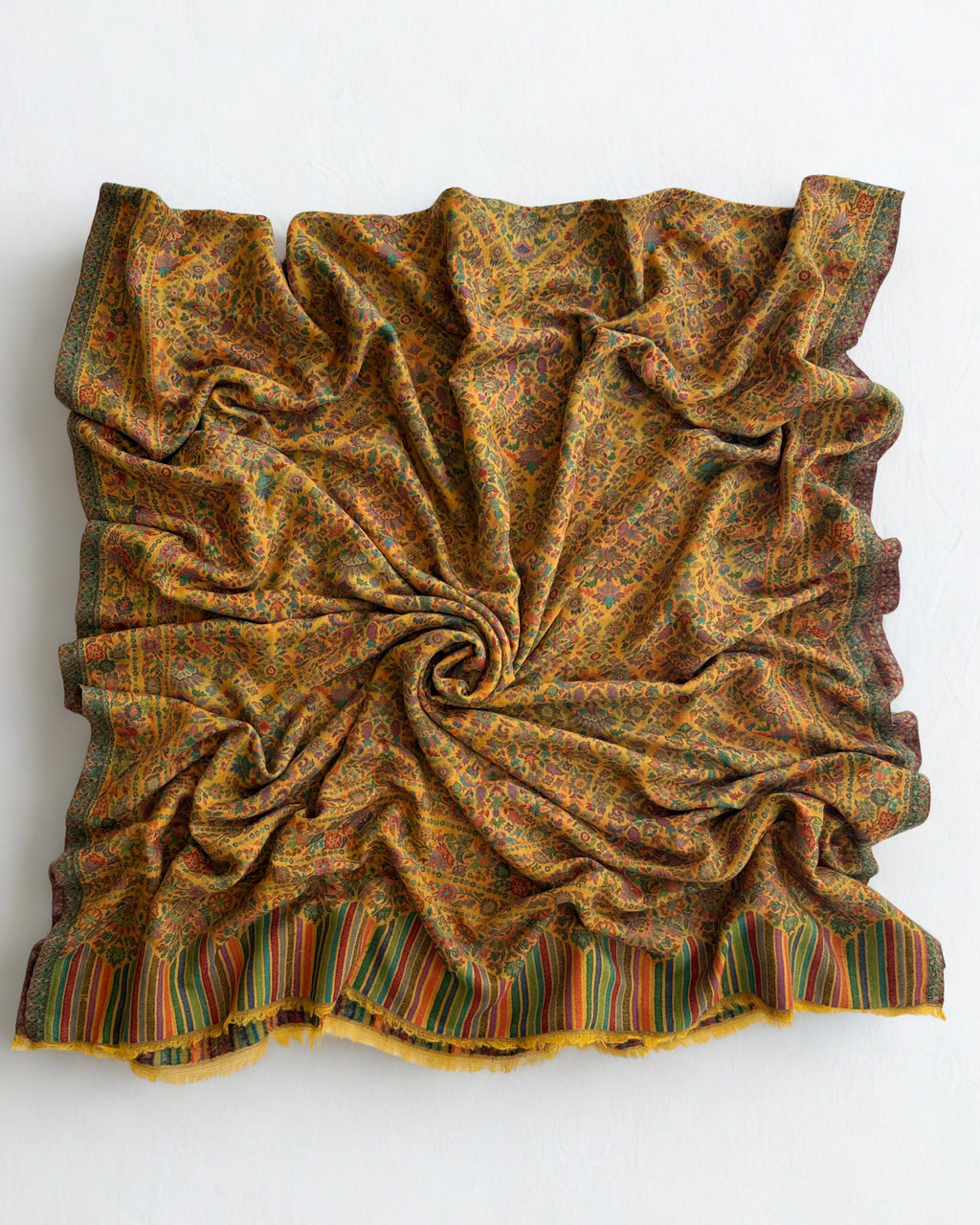 Detail of the striped end panel and arch motifs on a marigold jamawar pashmina shawl