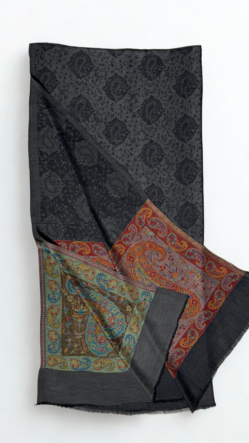 Dark charcoal Palladar shawl folded with one end turned back, showing both differently coloured jewel-tone paisley pallas