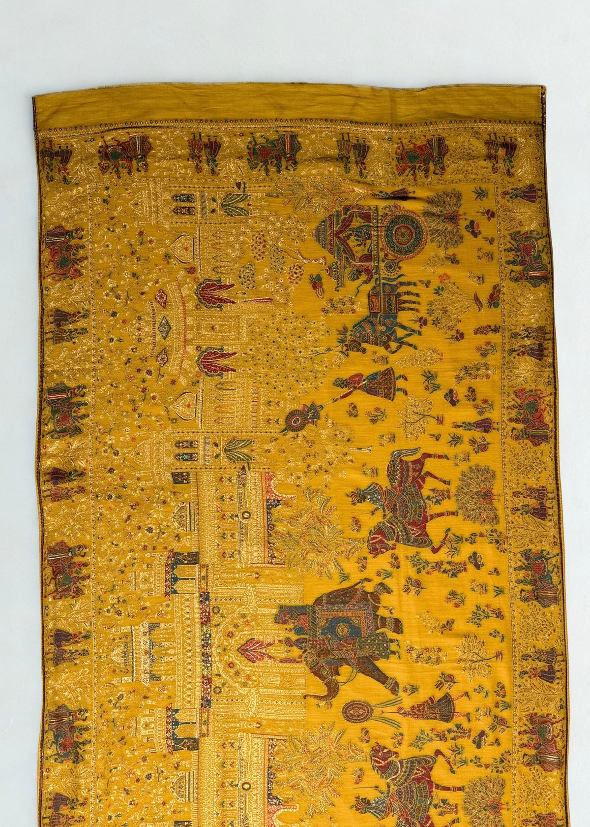 Mustard Mughal court Kani pashmina shawl in soft folds, gold zari elephants, horsemen and pavilions across the field