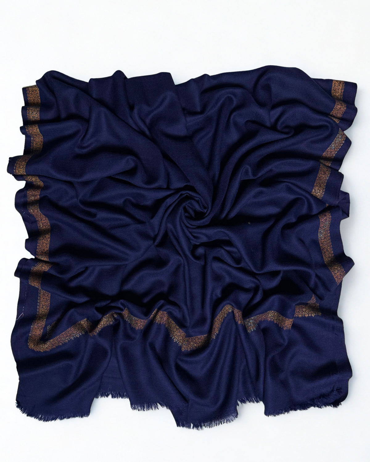 Navy Swati Shahtoosh shawl swirled open, showing the plain field and embroidered border on all four sides