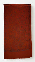 Rust Swati Shahtoosh shawl folded to show the hand-embroidered paisley field and triangular flower-head border