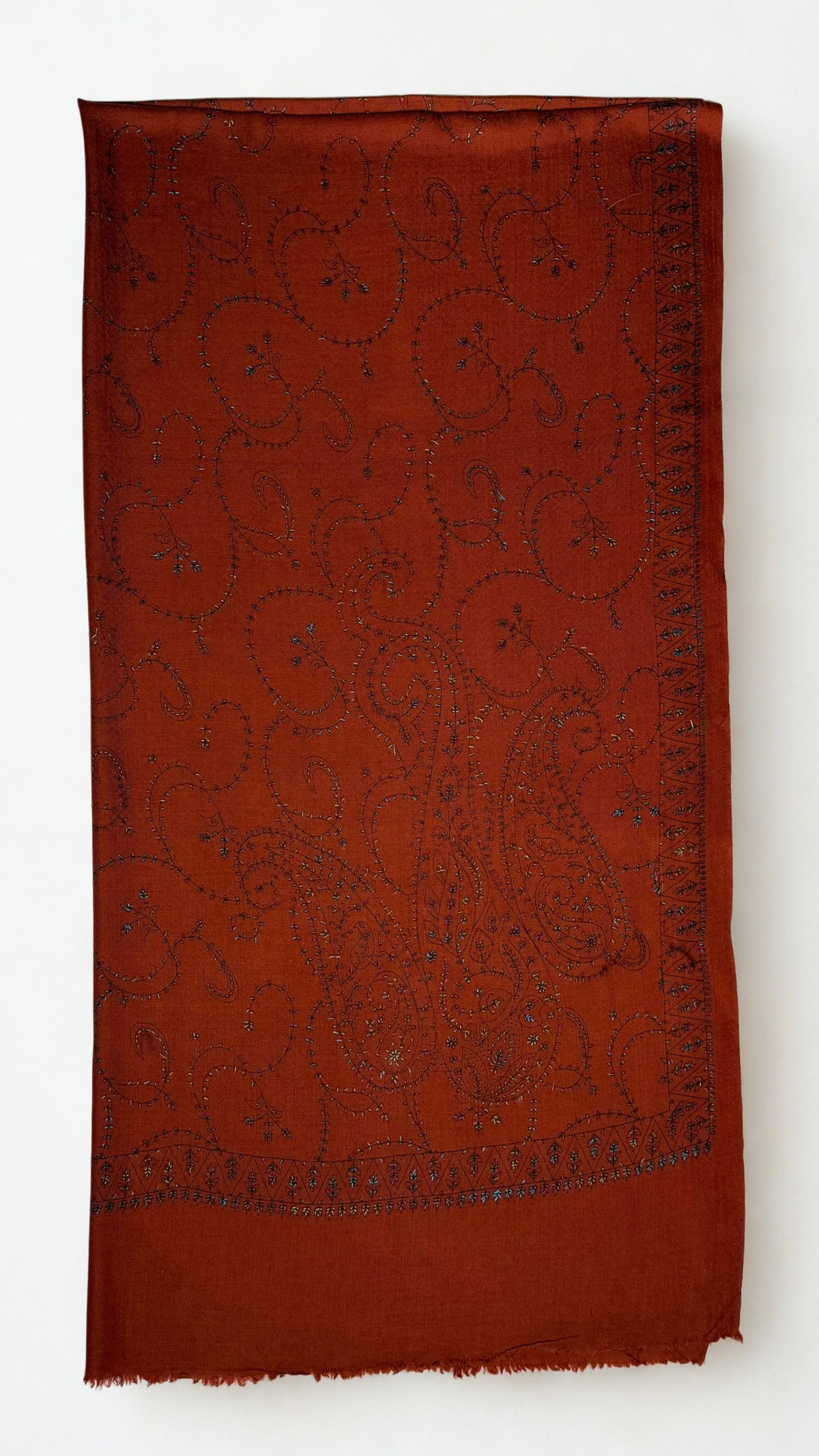 Rust Swati Shahtoosh shawl folded to show the hand-embroidered paisley field and triangular flower-head border