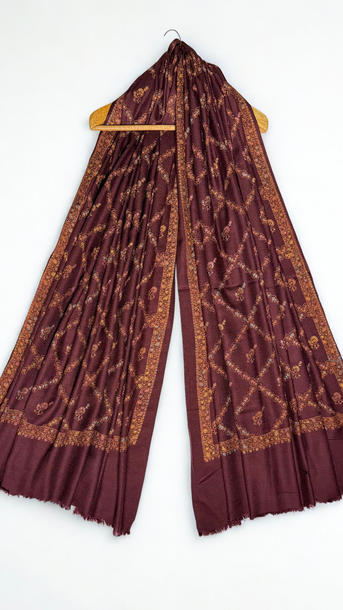 Wine Swati Shahtoosh shawl on a hanger, copper jaal embroidery running the full length