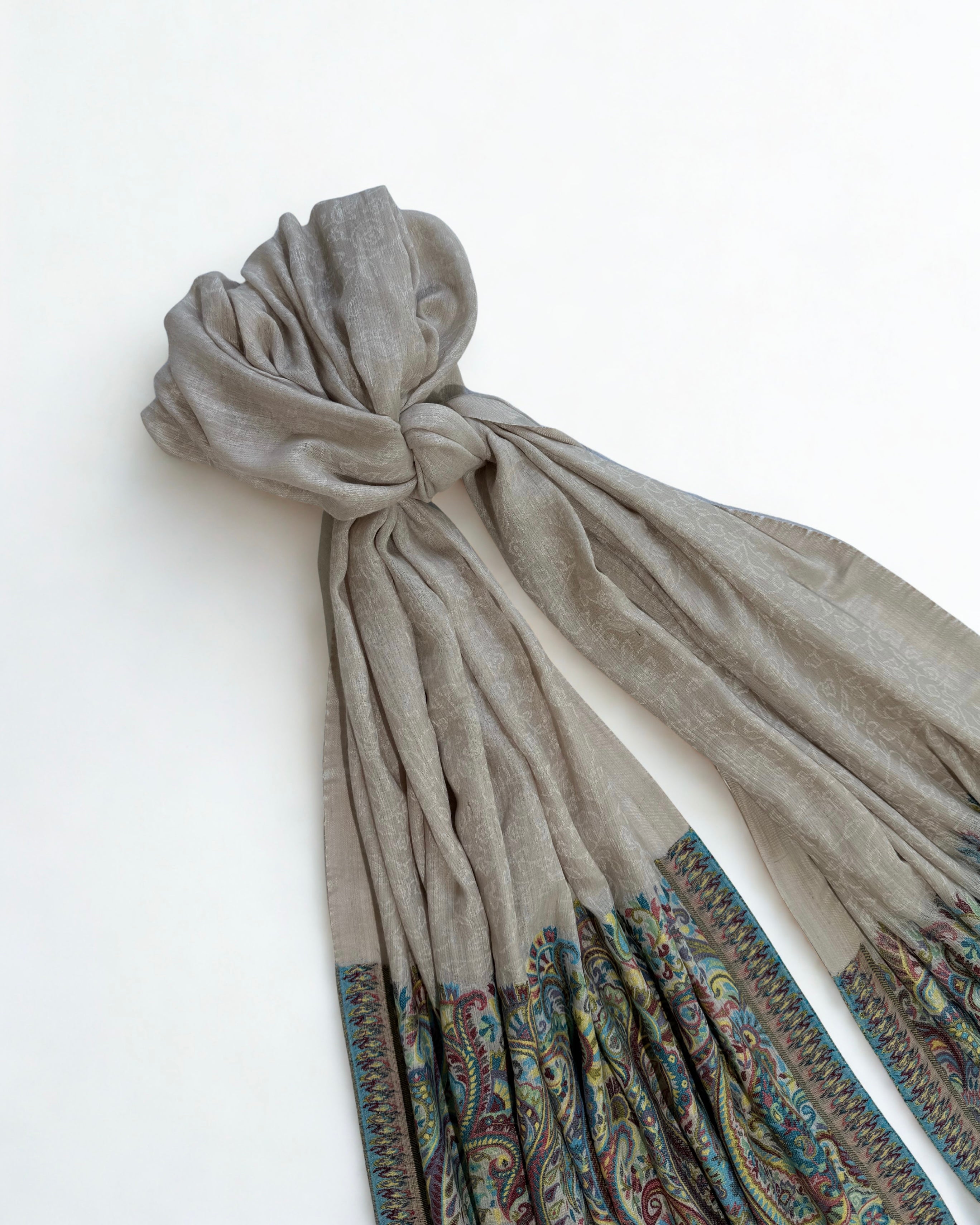 Self-patterned scrolling vine woven into the stone grey ground in the same colour