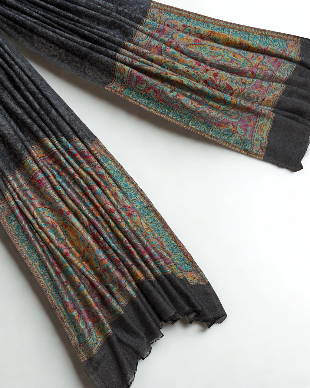 Graphite pashmina shawl swirled to show its drape above the coloured palla