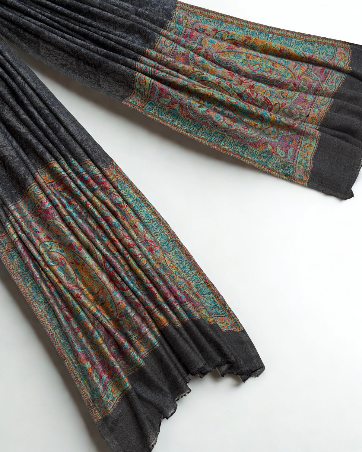 Graphite pashmina shawl swirled to show its drape above the coloured palla