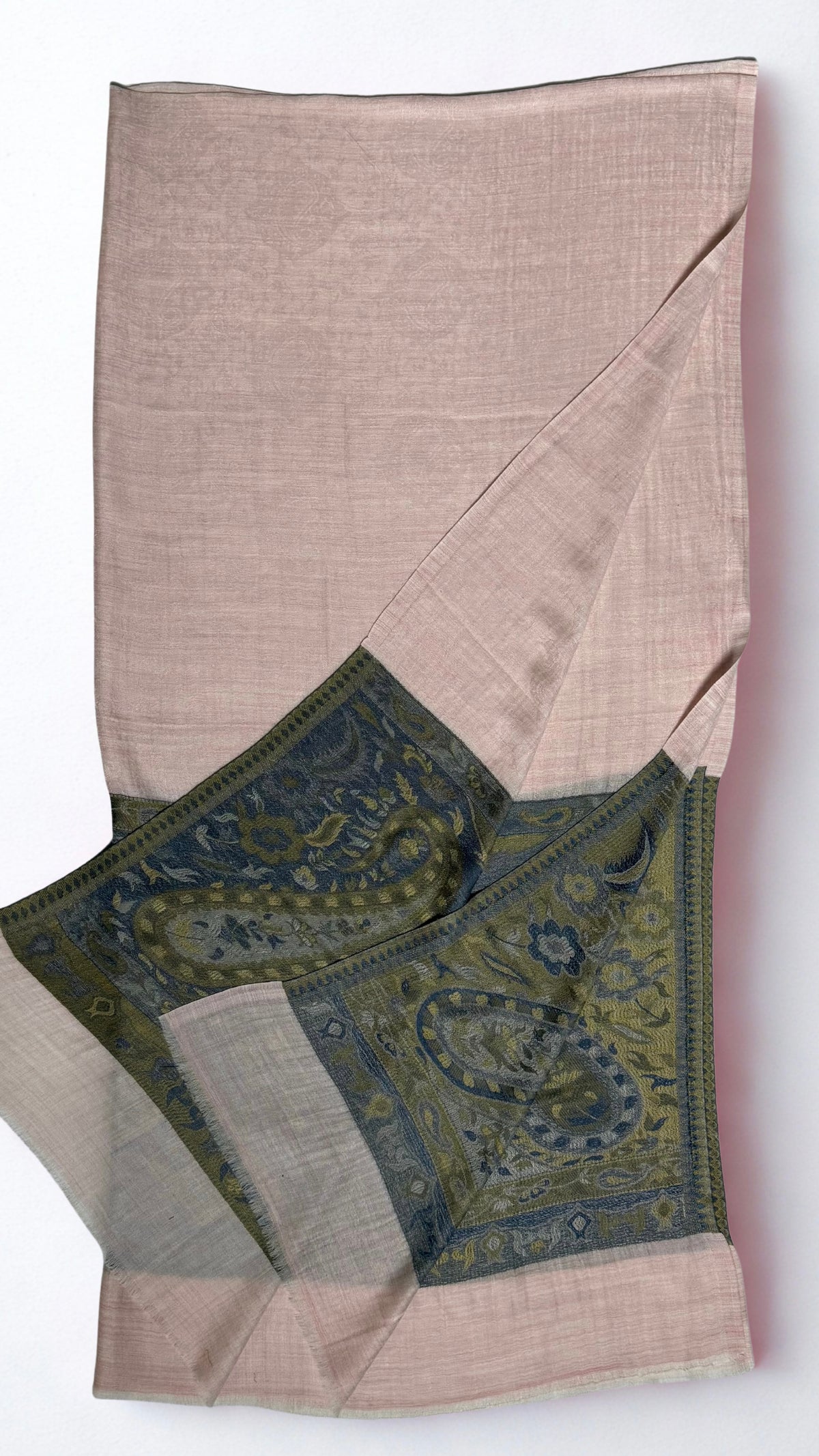 Blush pink Palladar ring shawl folded with one end turned back, showing the woven olive and indigo paisley palla and plain pink end panel