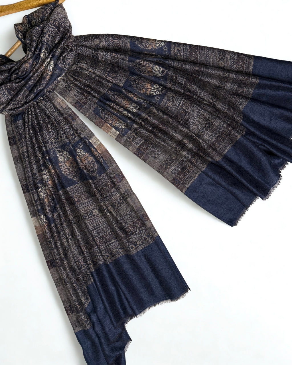 Indigo and bronze Indian pashmina shawl folded to show the banded paisley weave and plain indigo end panels
