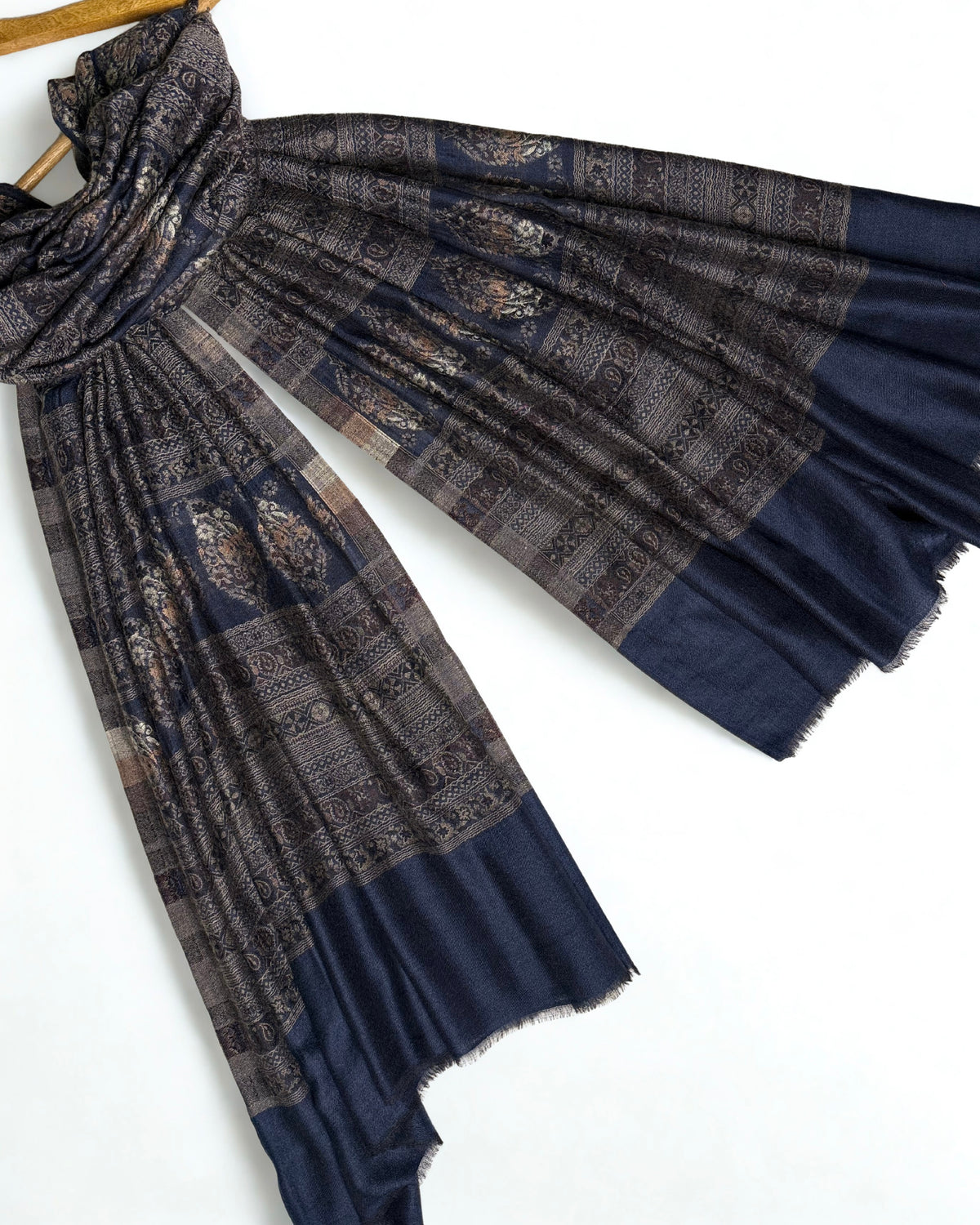 Indigo and bronze Indian pashmina shawl folded to show the banded paisley weave and plain indigo end panels