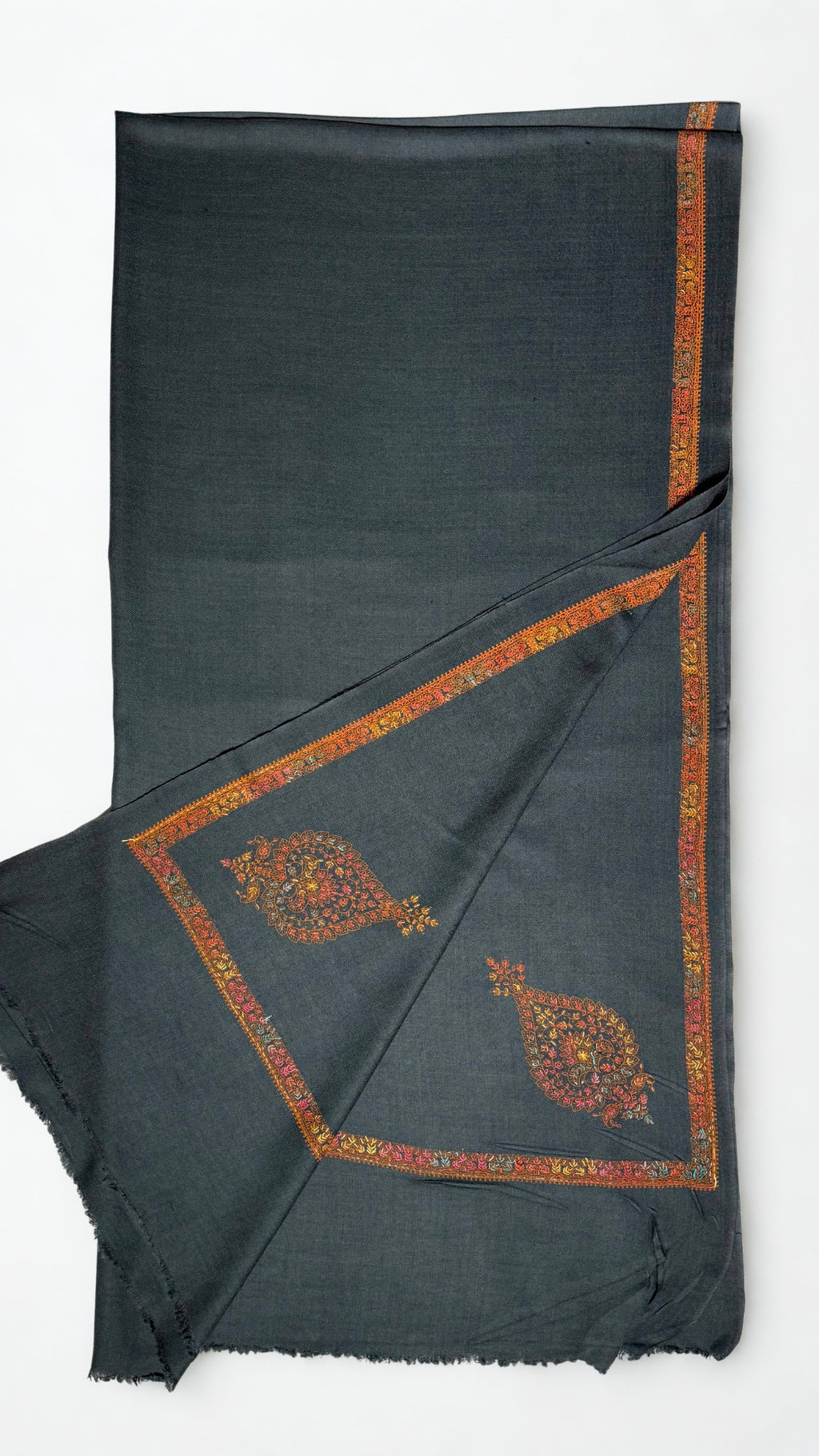 Charcoal Swati Shahtoosh shawl folded back to show the rust hand-embroidered border and corner paisleys