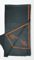 Charcoal Swati Shahtoosh shawl folded back to show the rust hand-embroidered border and corner paisleys