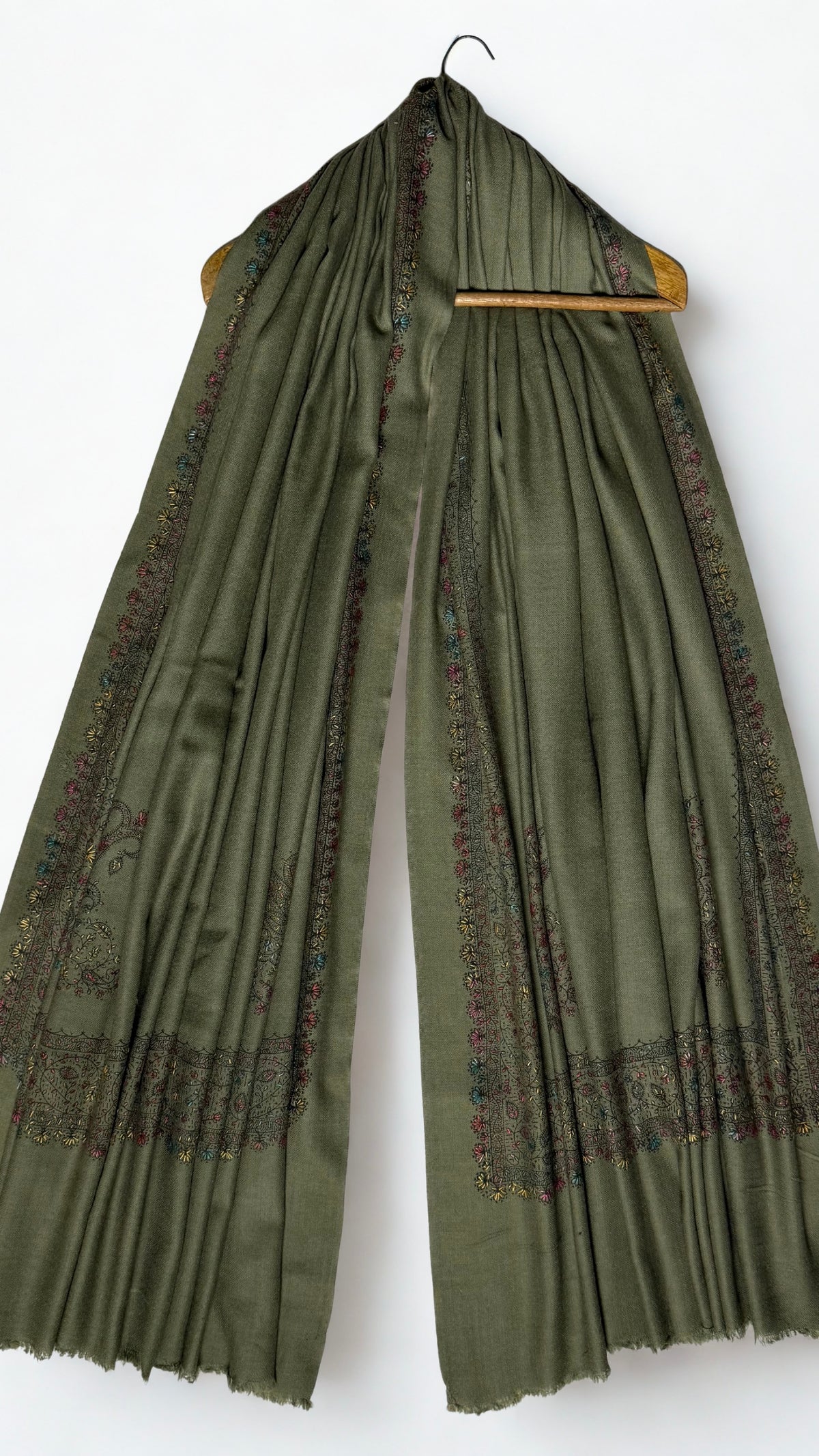 Olive green Swati Shahtoosh shawl on a hanger, hand-embroidered floral border running down both ends