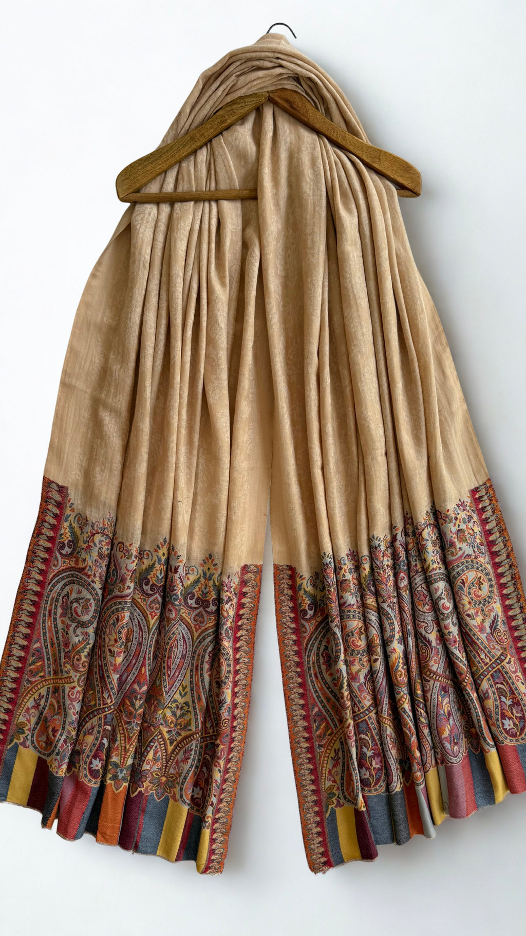 Sand Palladar shawl on a wooden hanger, both paisley borders visible