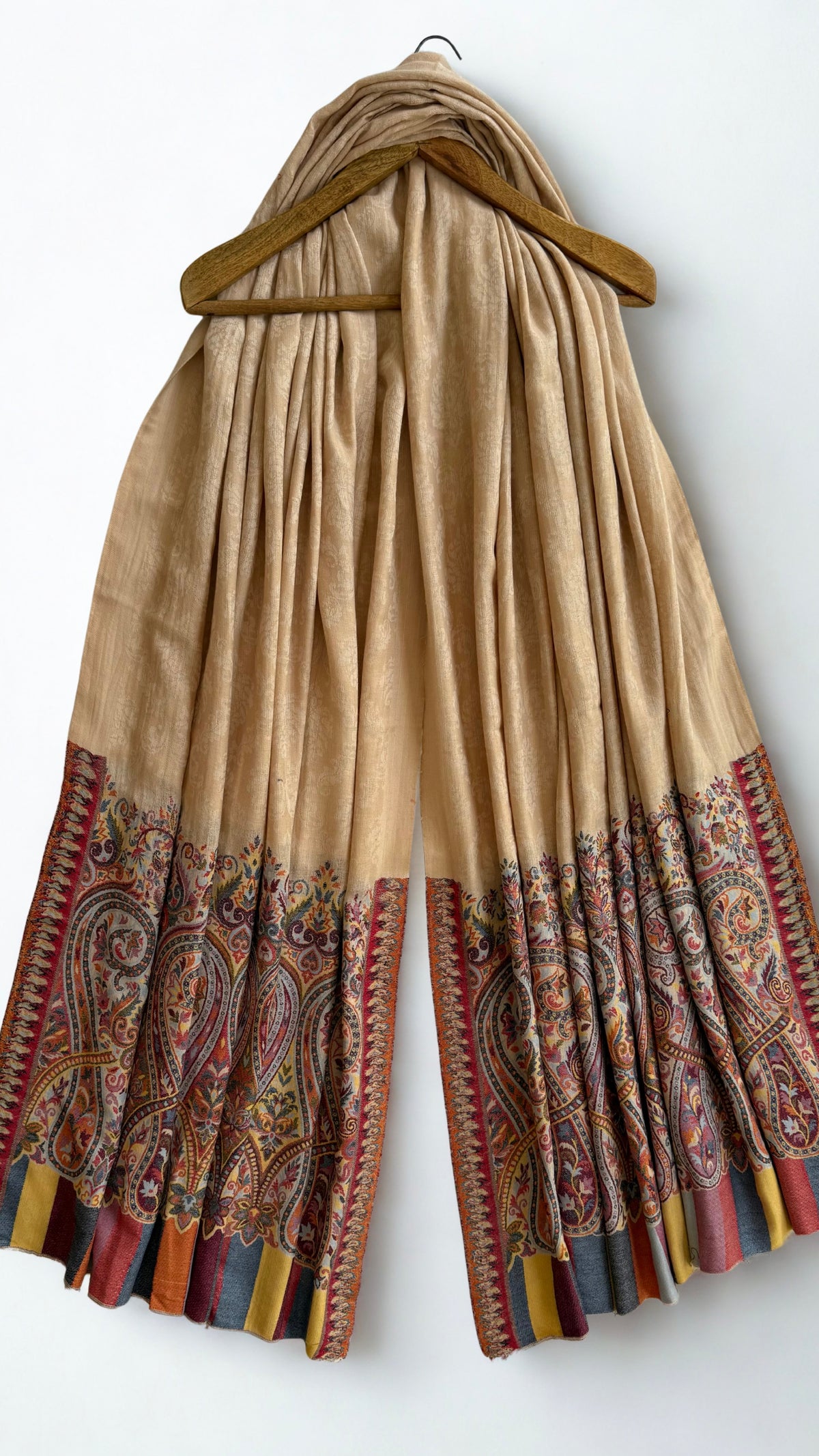 Sand Palladar shawl on a wooden hanger, both paisley borders visible