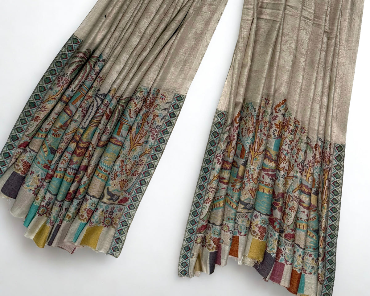 Shawl folded back to show the reverse of the landscape panel and the striped edge