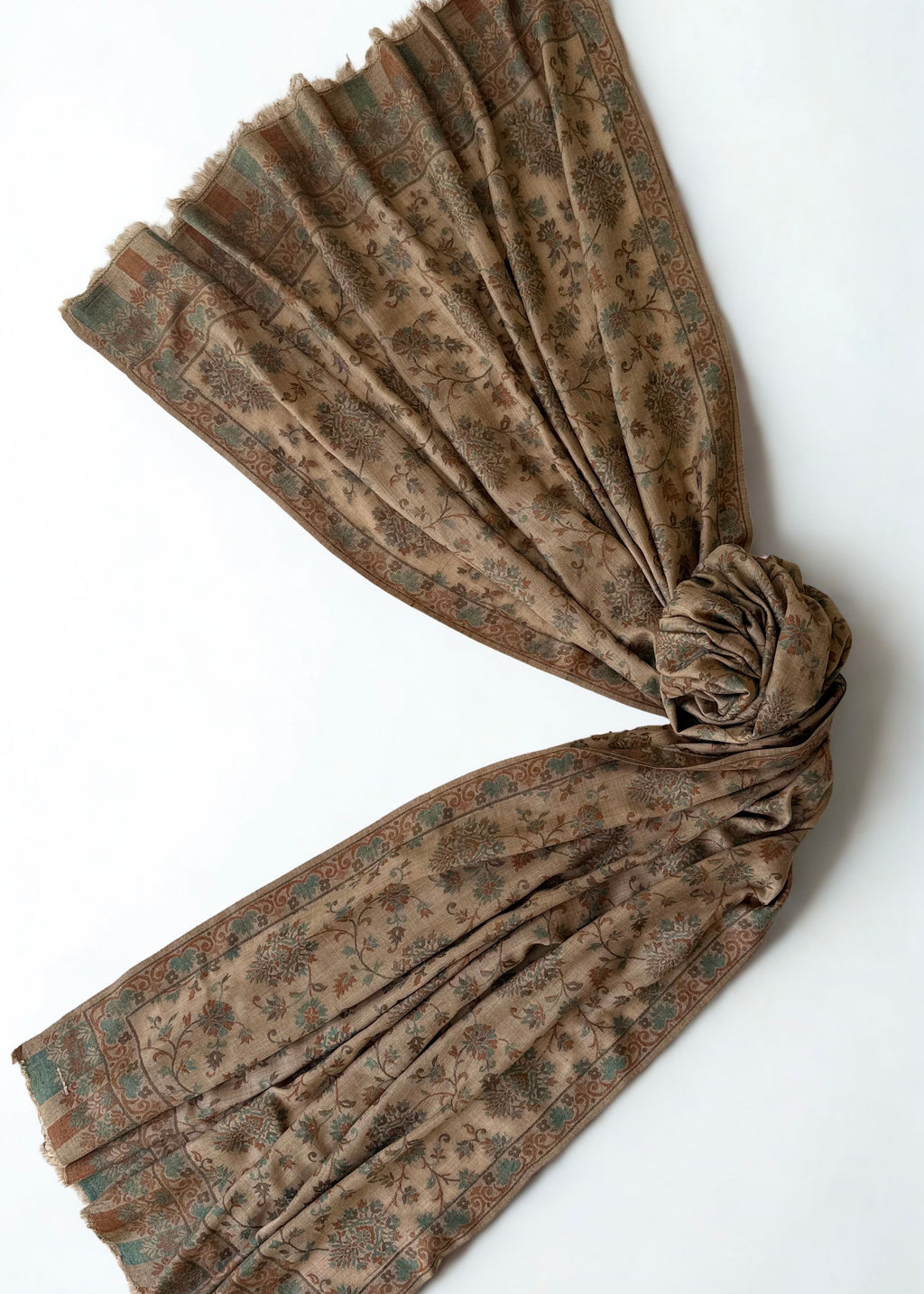 Close view of the verdigris and rust flowering vines woven into a camel pashmina ground