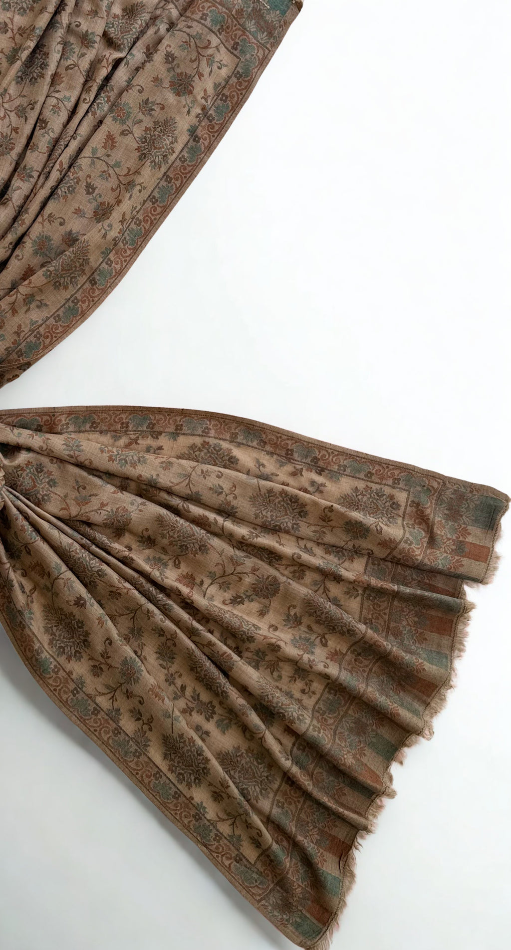 Detail of the scrolling border and striped fringed end on a camel Kani pashmina shawl