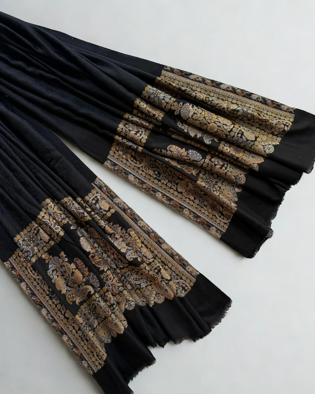 Self-patterned damask medallion woven into the black ground in the same colour