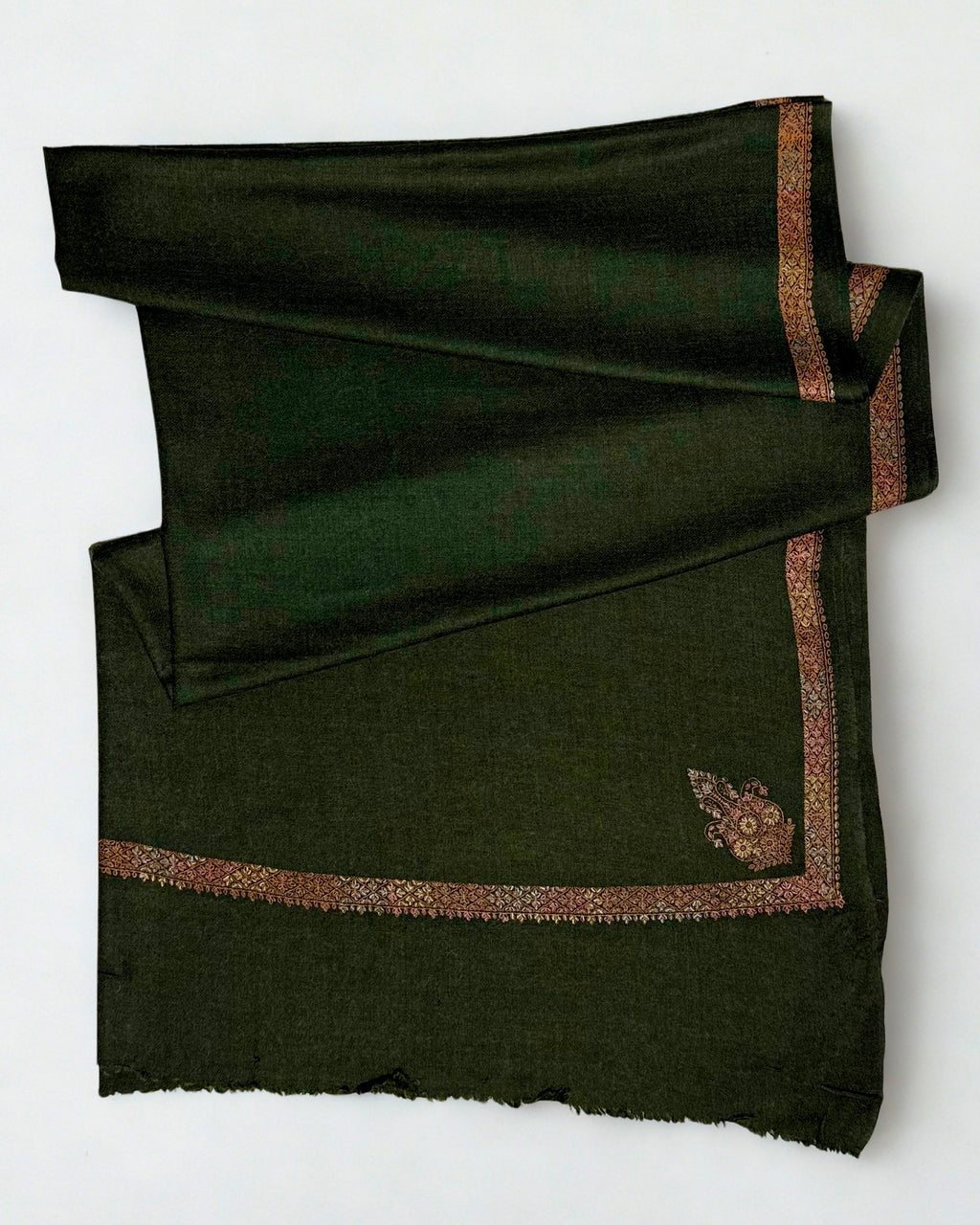 Forest green Swati Shahtoosh shawl folded in soft layers, rose and coral embroidery glowing against the deep green ground