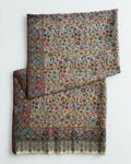 Ivory Zari Kani pashmina shawl laid flat, dense scattered floral field framed by a deep slate border and fringed end band