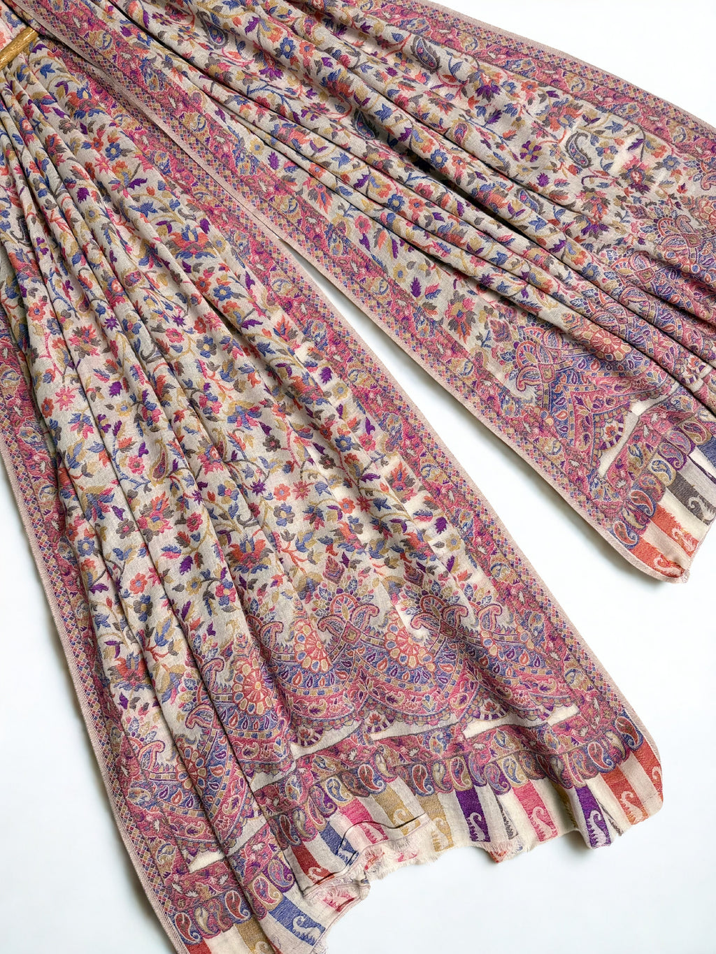 Close view of the cornflower blue and rose Kani floral weave falling in soft pleats from a hanger
