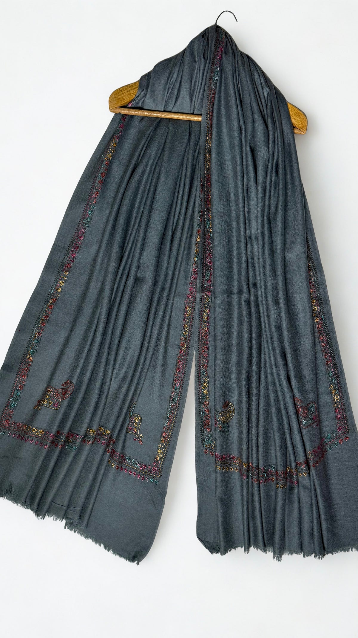 Slate grey Swati Shahtoosh shawl on a hanger, embroidered floral border running down both ends