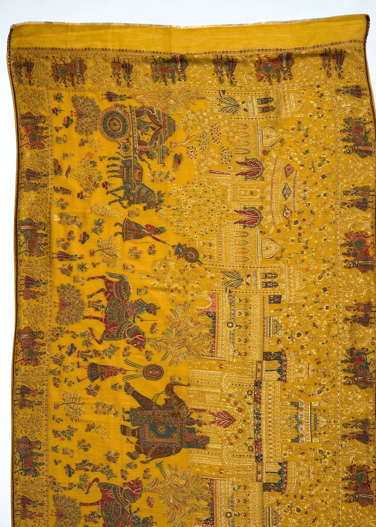 Mughal court Kani pashmina shawl folded back to reveal the plain mustard pashmina backing that protects the reverse