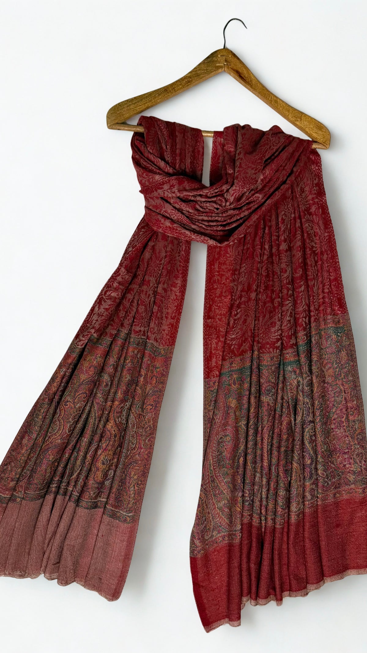 Close view of the woven paisley border in antique rose, moss green, saffron and plum