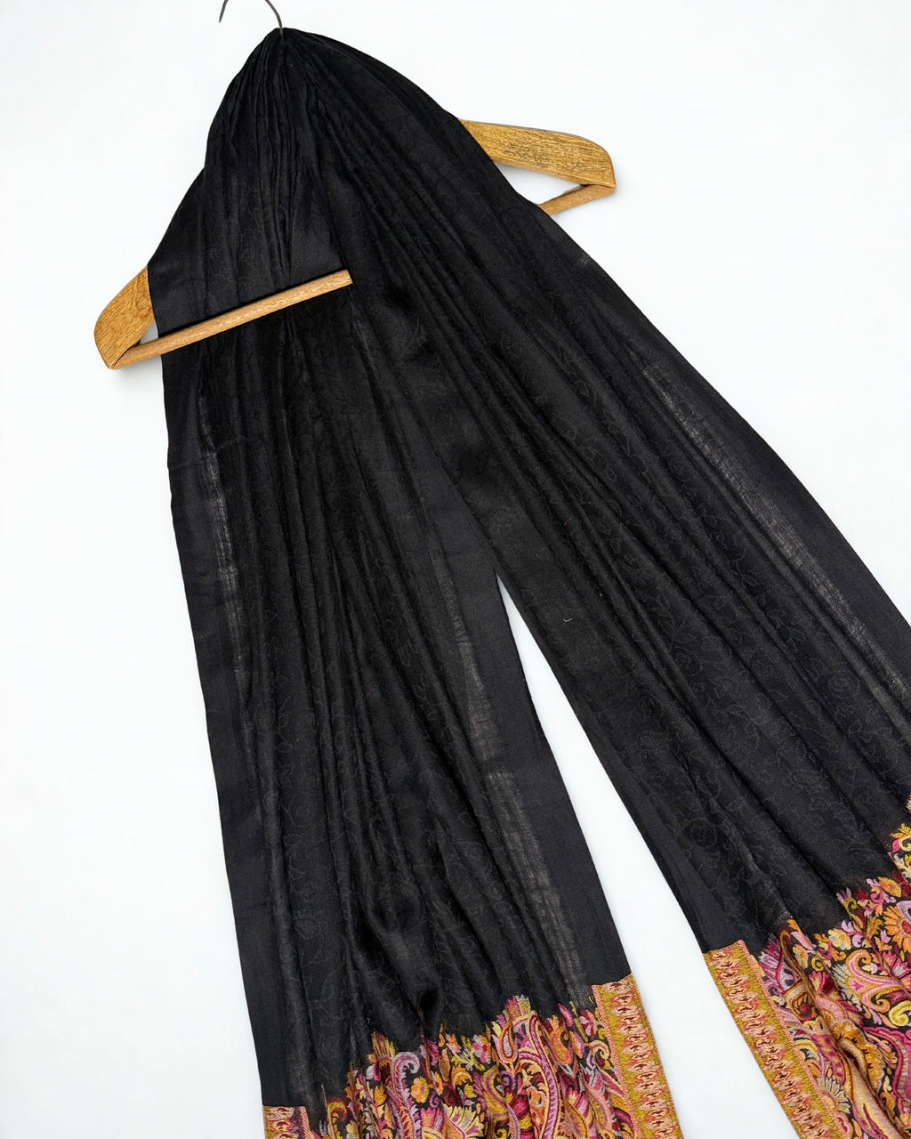 Black ek rukh Palladar shawl spread flat, showing the self-patterned black field above the full rose-gold paisley end panel