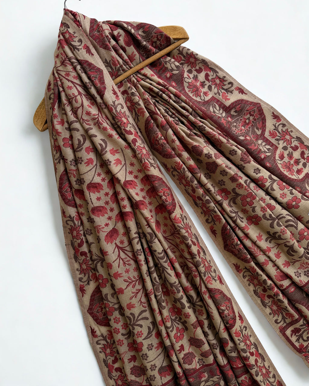 Taupe and rosewood Kani pashmina shawl folded back to show the reverse of the woven floral pattern and the striped end band