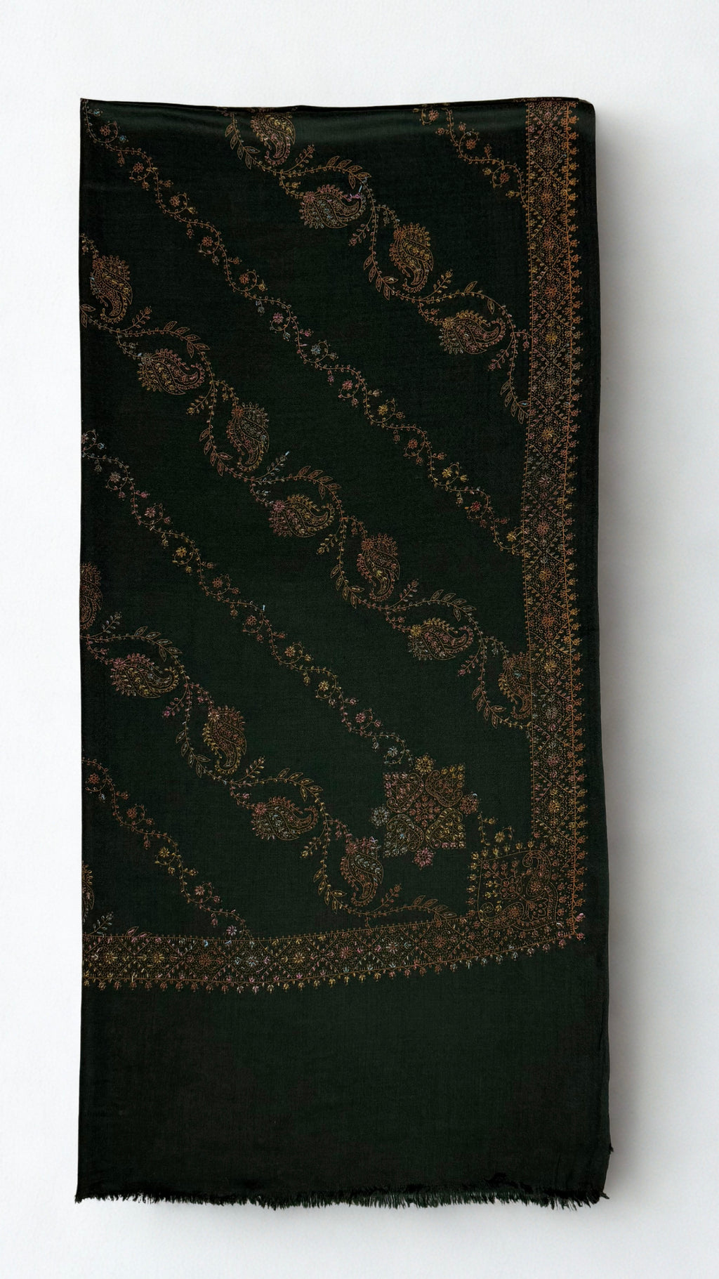 Forest green Swati Shahtoosh shawl folded, showing diagonal rows of hand-embroidered paisley and vine, corner medallion, embroidered border and plain fringed end