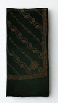 Forest green Swati Shahtoosh shawl folded, showing diagonal rows of hand-embroidered paisley and vine, corner medallion, embroidered border and plain fringed end