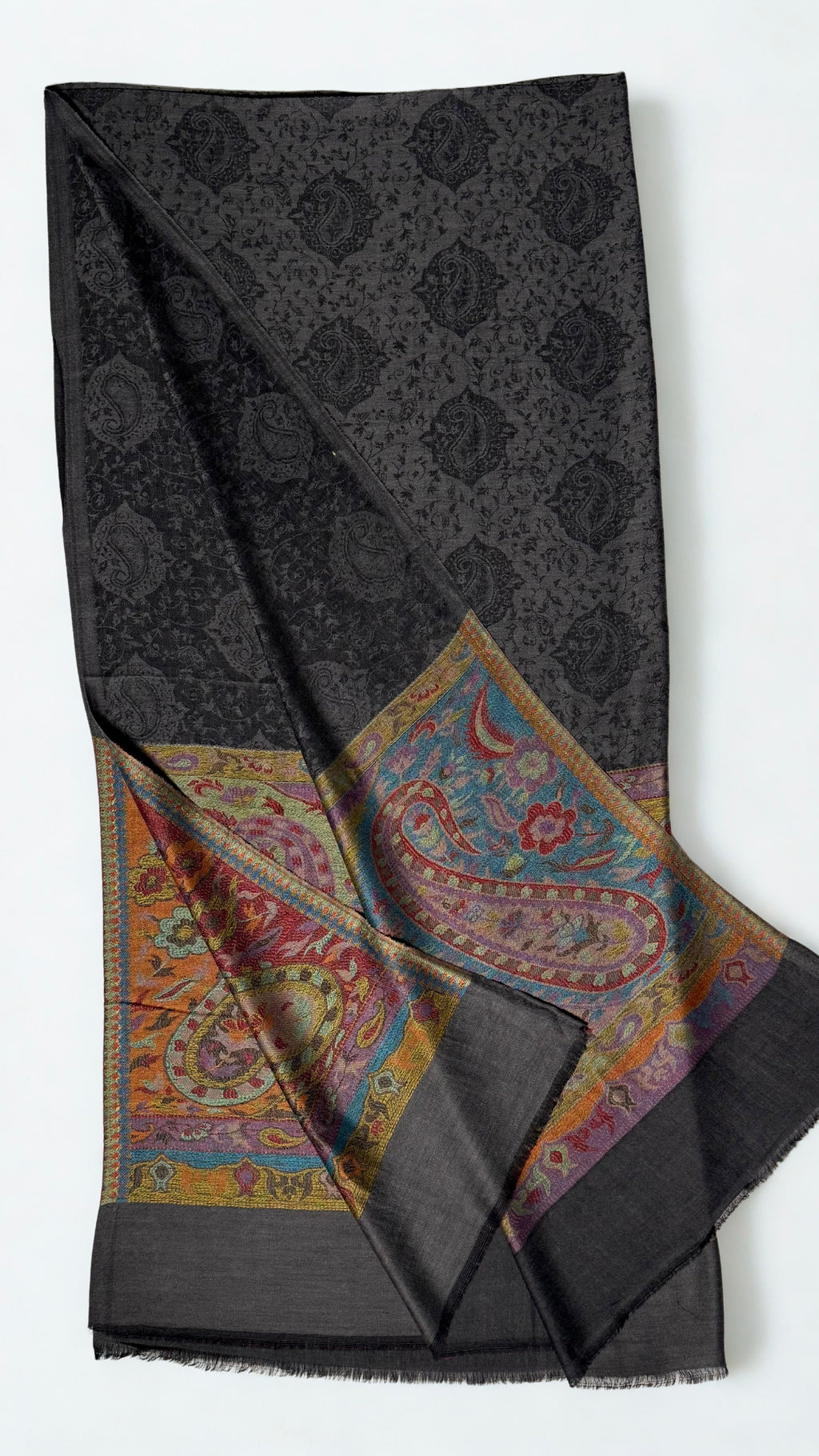 Dark charcoal Palladar shawl folded with one end turned back, showing both saffron, crimson and teal woven paisley pallas