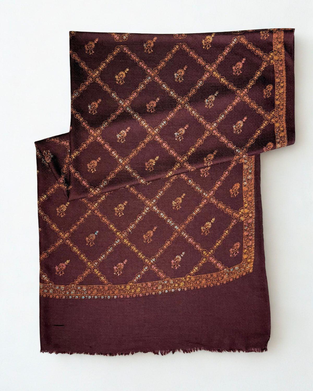 Wine Swati Shahtoosh shawl folded flat, copper trellis with a flowering buti in each compartment