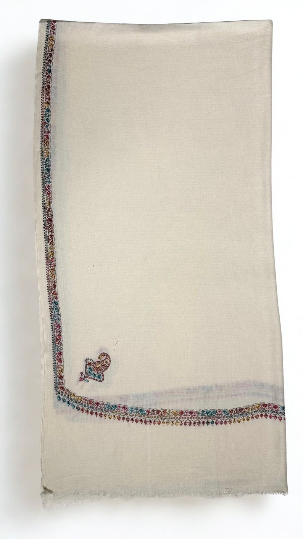White Swati Shahtoosh shawl folded lengthwise, fine multicoloured hand-embroidered border with a paisley corner buta
