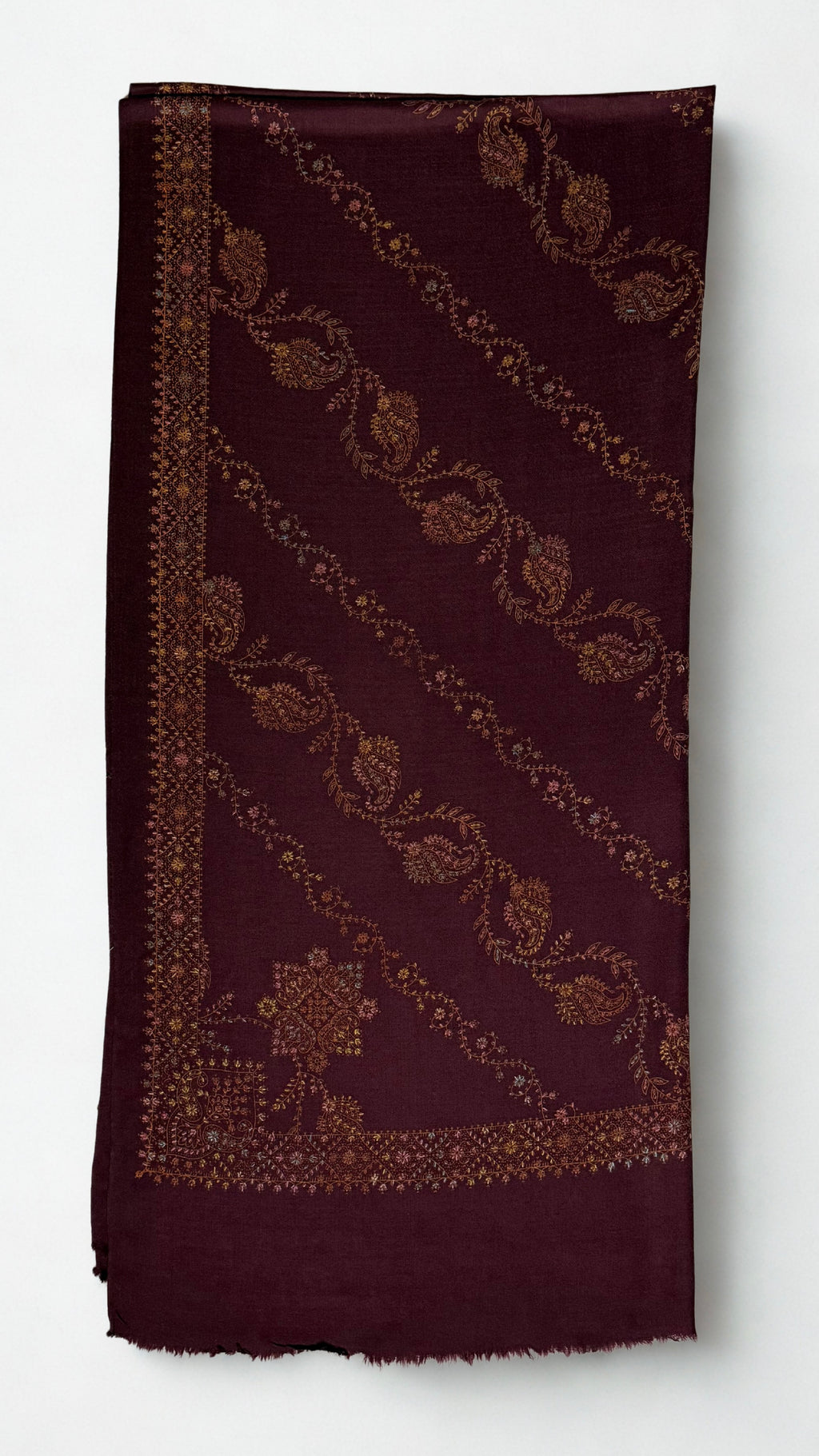 Deep maroon Swati Shahtoosh shawl folded, showing diagonal rows of hand-embroidered paisley and vine, corner medallion, embroidered border and plain fringed end