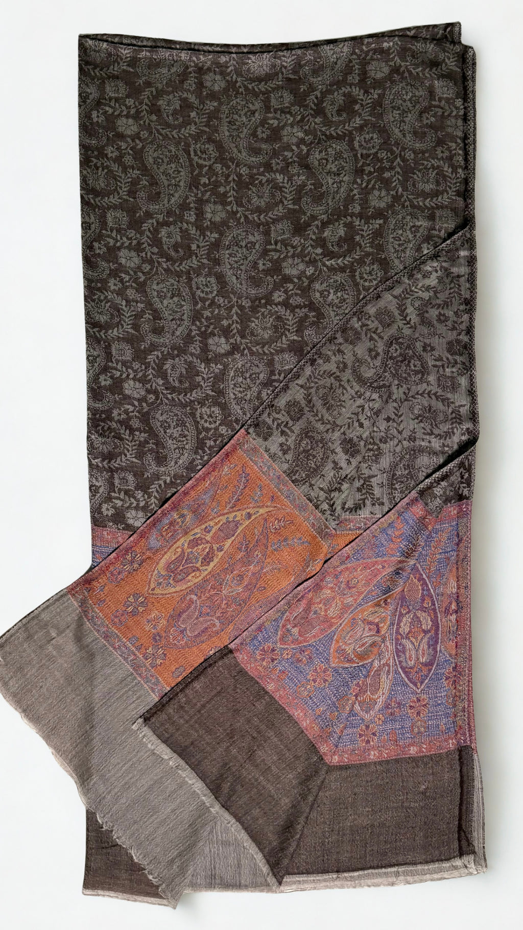 Close view of the tall paisleys in rust, apricot and plum on a periwinkle-blue ground