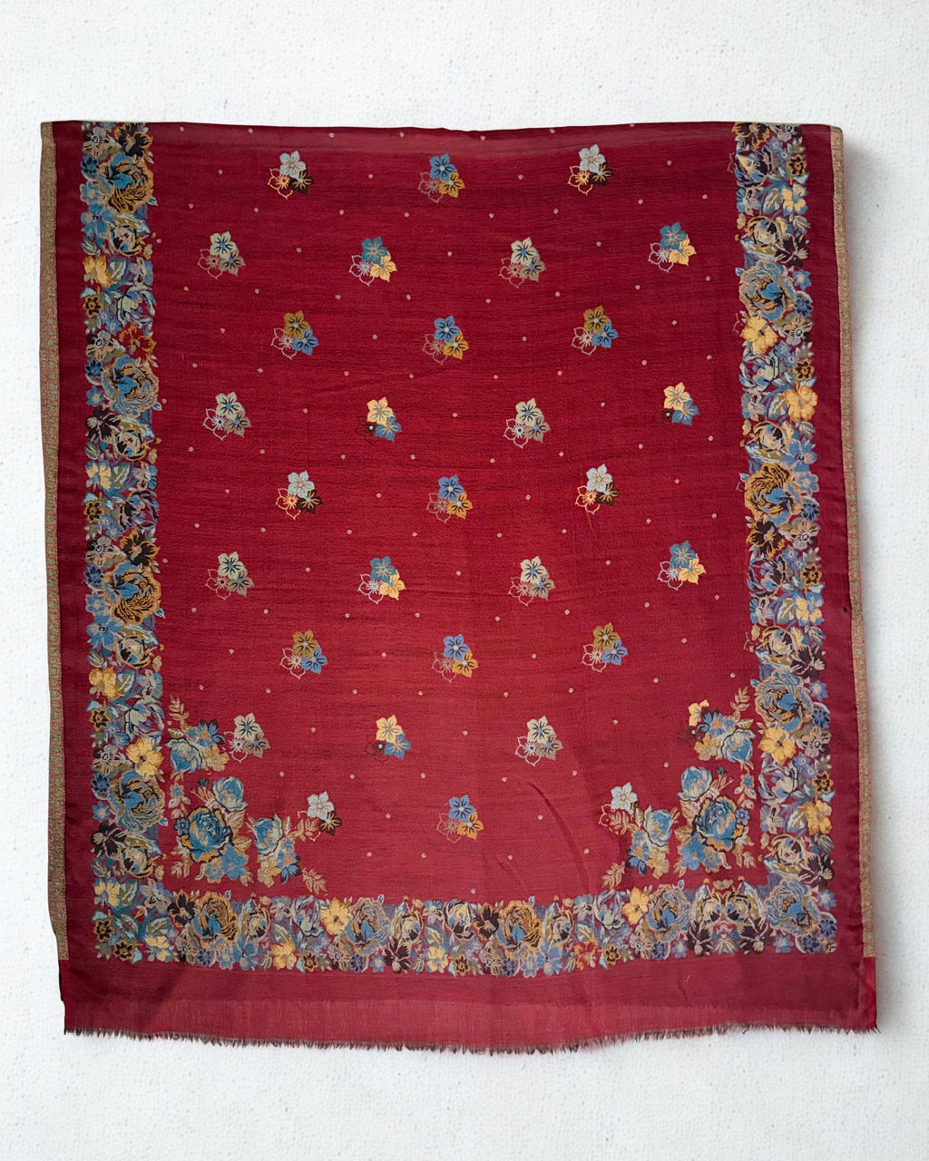 Claret and blue rose Kani pashmina shawl spread out, showing the open field and the full floral border on all four sides