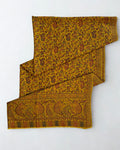 Mustard Kani pashmina shawl laid flat, handwoven paisley and floral field with a wide patterned end border