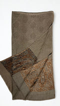 Warm khaki pashmina ring shawl folded with one end turned back, showing the woven medallion field and both paisley pallas in copper and deep brown