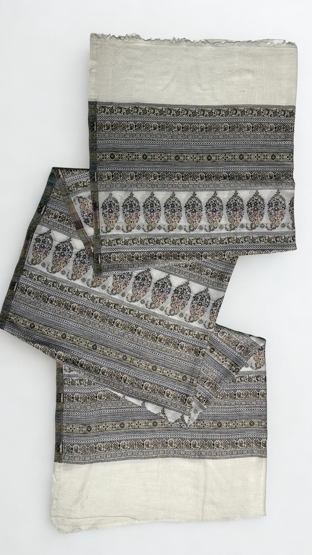 Silver grey Indian pashmina shawl gathered over a hanger, showing the softness of the drape and the fine banded pattern