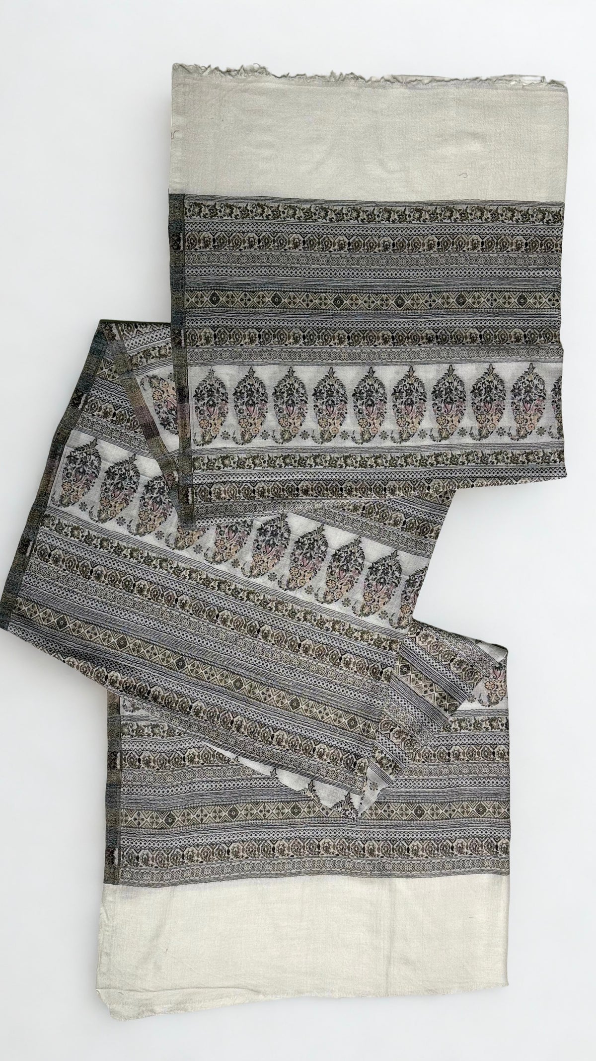Silver grey Indian pashmina shawl gathered over a hanger, showing the softness of the drape and the fine banded pattern